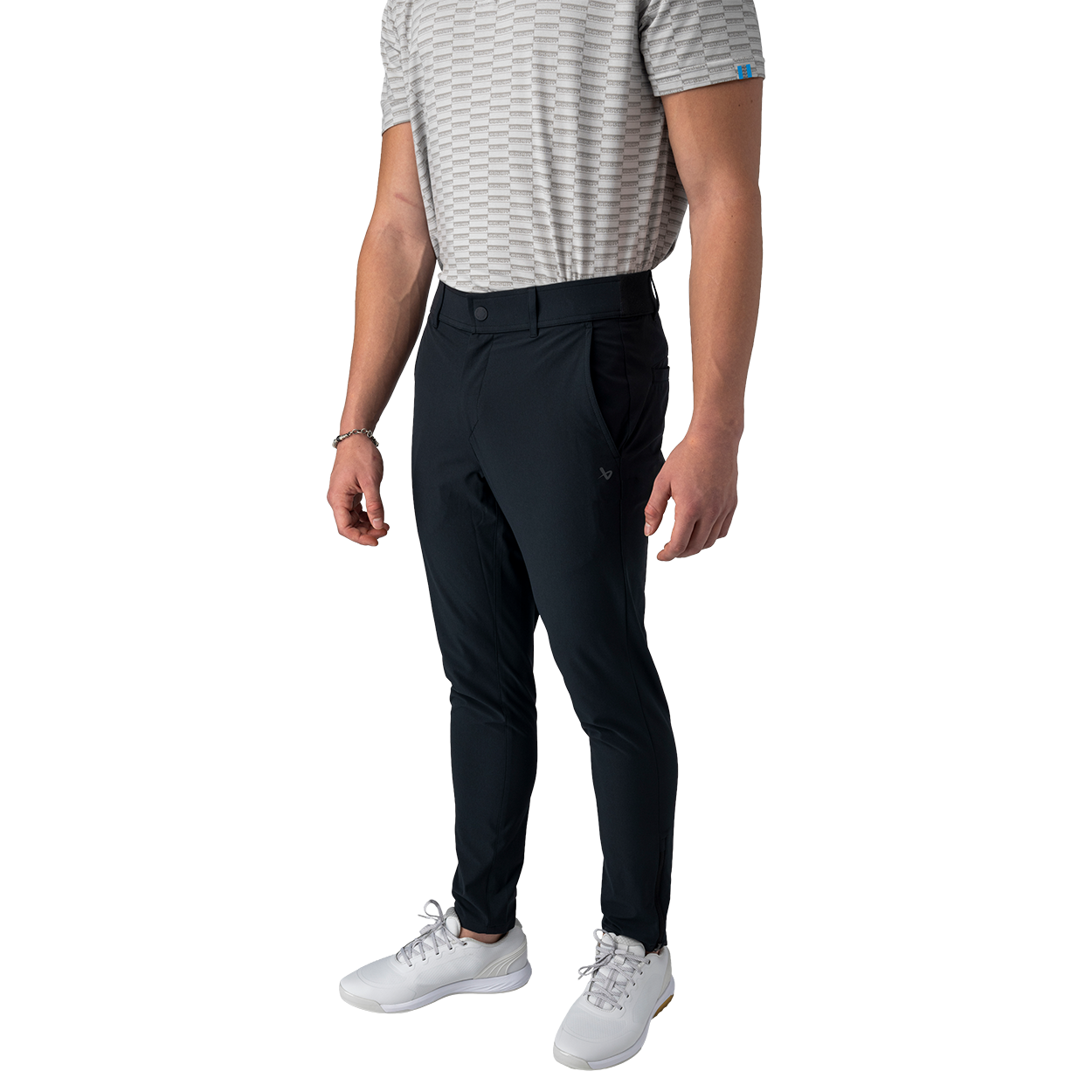 Person wearing black pants and white shoes on a white background